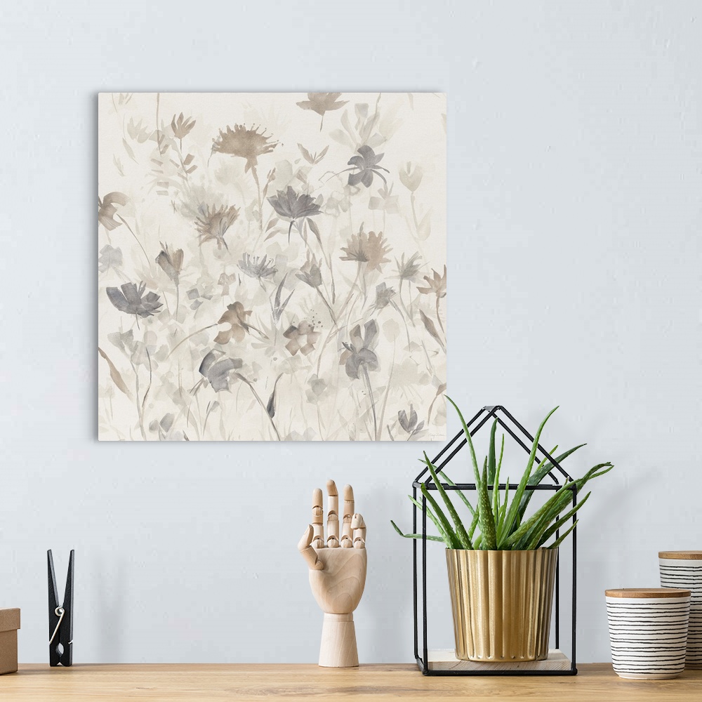 A bohemian room featuring Square abstract watercolor painting of neutral and gray toned flower silhouettes.