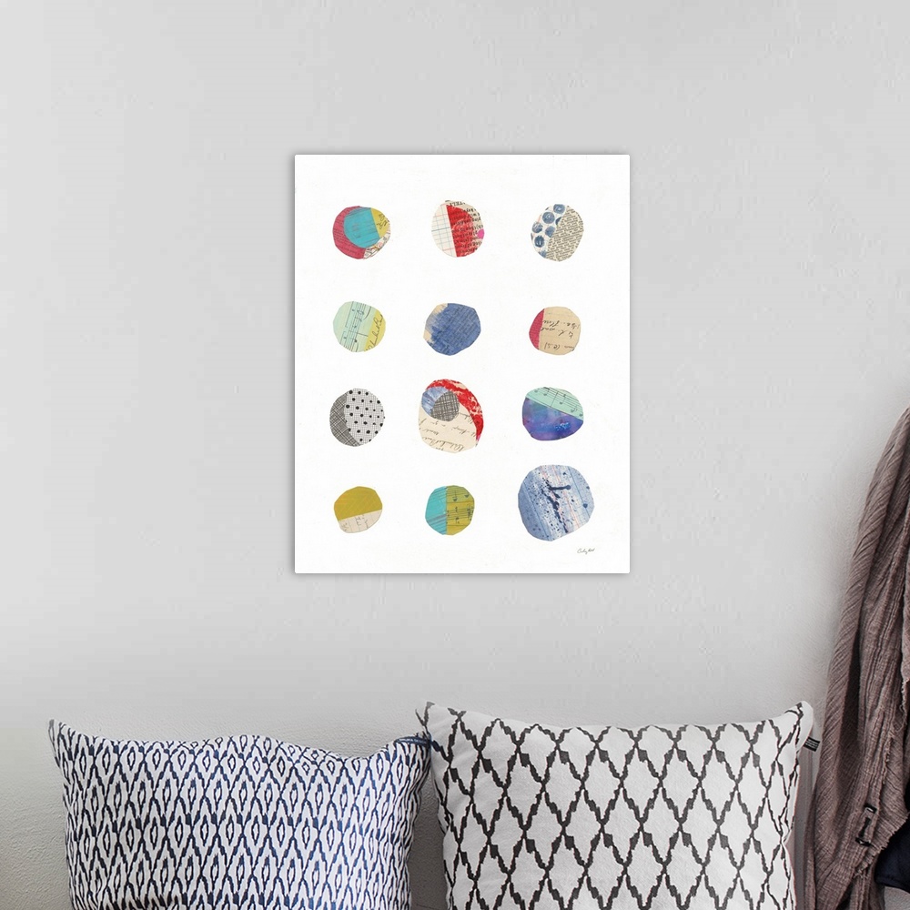 A bohemian room featuring Mixed media abstract art with colorfully cut out circles placed in rows on a white background.