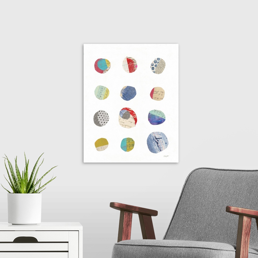 A modern room featuring Mixed media abstract art with colorfully cut out circles placed in rows on a white background.