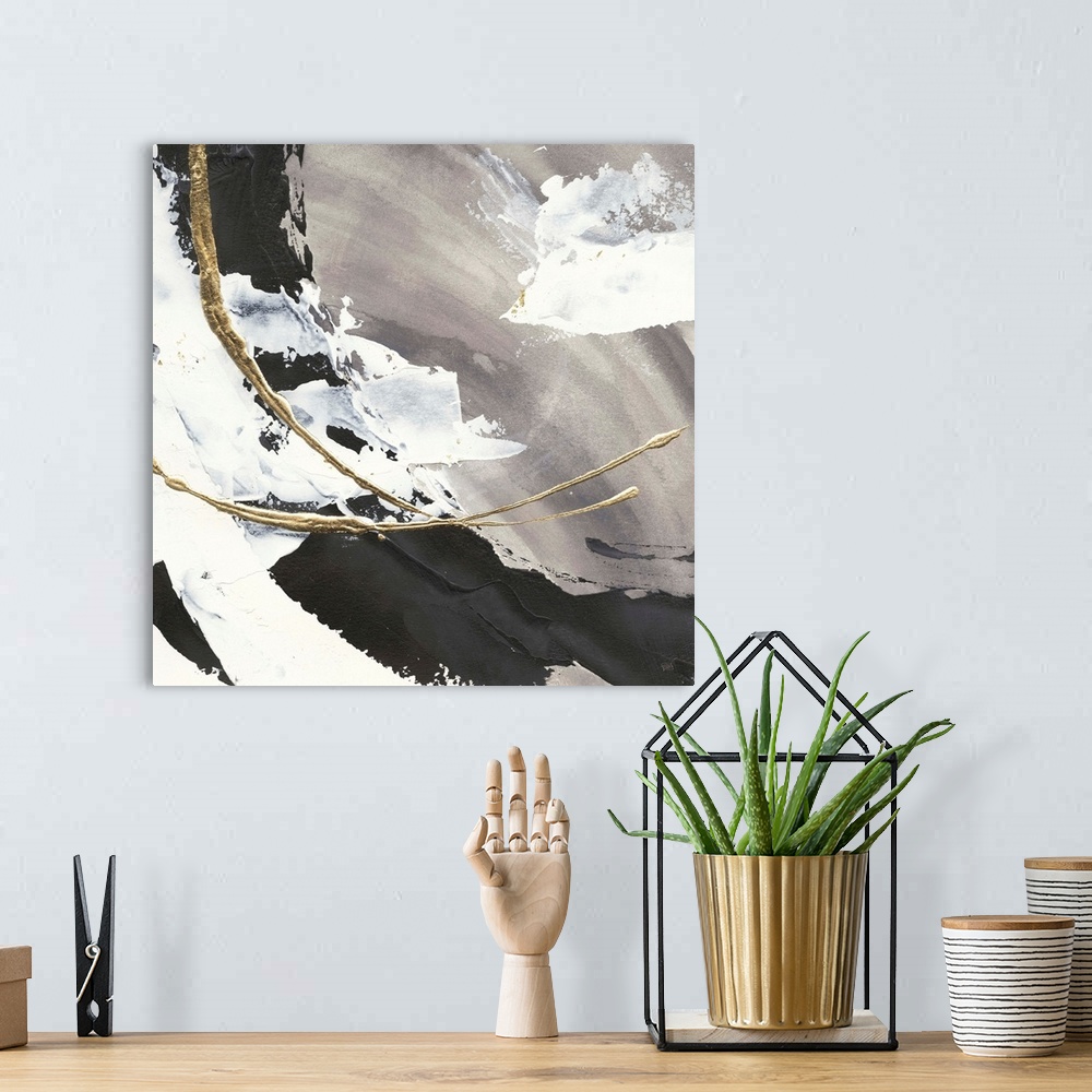 A bohemian room featuring Large abstract painting of various brush strokes of gray, black and white with gold line accents.