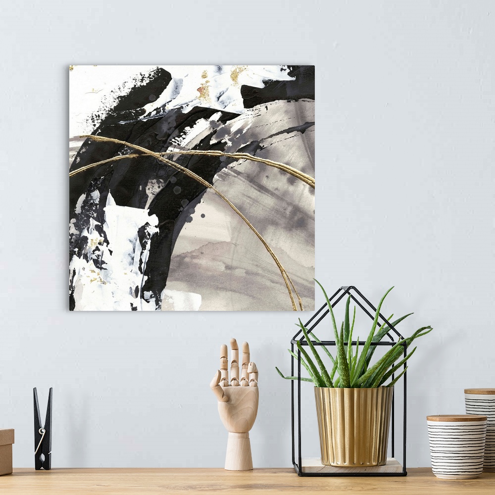 A bohemian room featuring Large abstract painting of various brush strokes of gray, black and white with gold line accents.