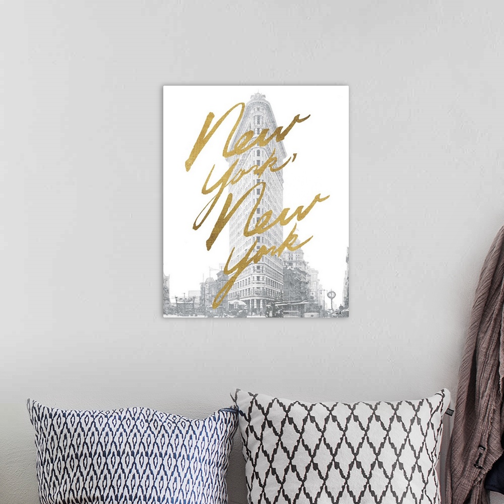 A bohemian room featuring Gold handlettering against a muted black and white photograph of the flat iron building in New Yo...