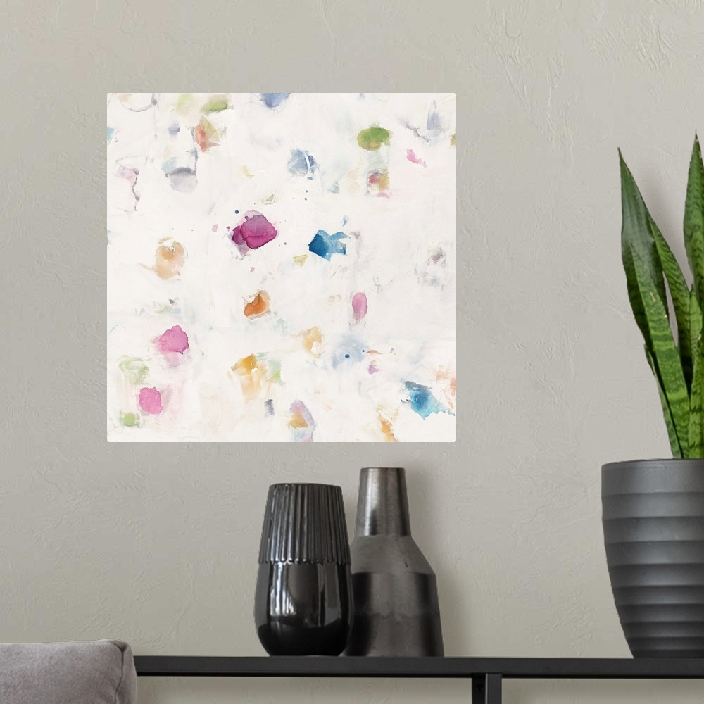 A modern room featuring Square abstract watercolor painting with a white background and colorful splash marks scattered a...