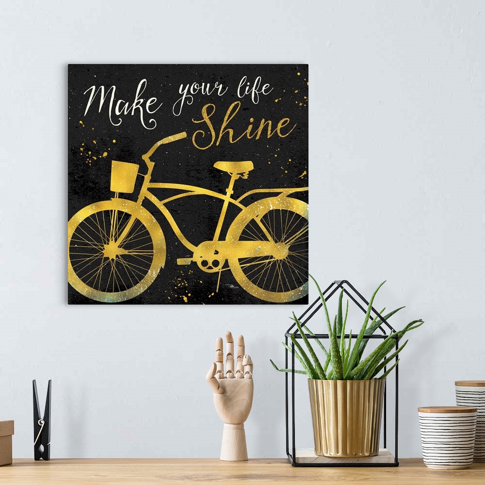 A bohemian room featuring Silhouette of a bicycle in gold with "Make your life shine" above it.