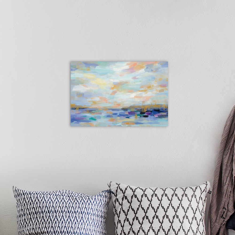A bohemian room featuring An abstract landscape of a sunrise seascape in varies warm colors.
