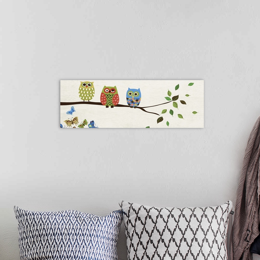 A bohemian room featuring Contemporary artwork of owls in multiple colors perched on a branch.