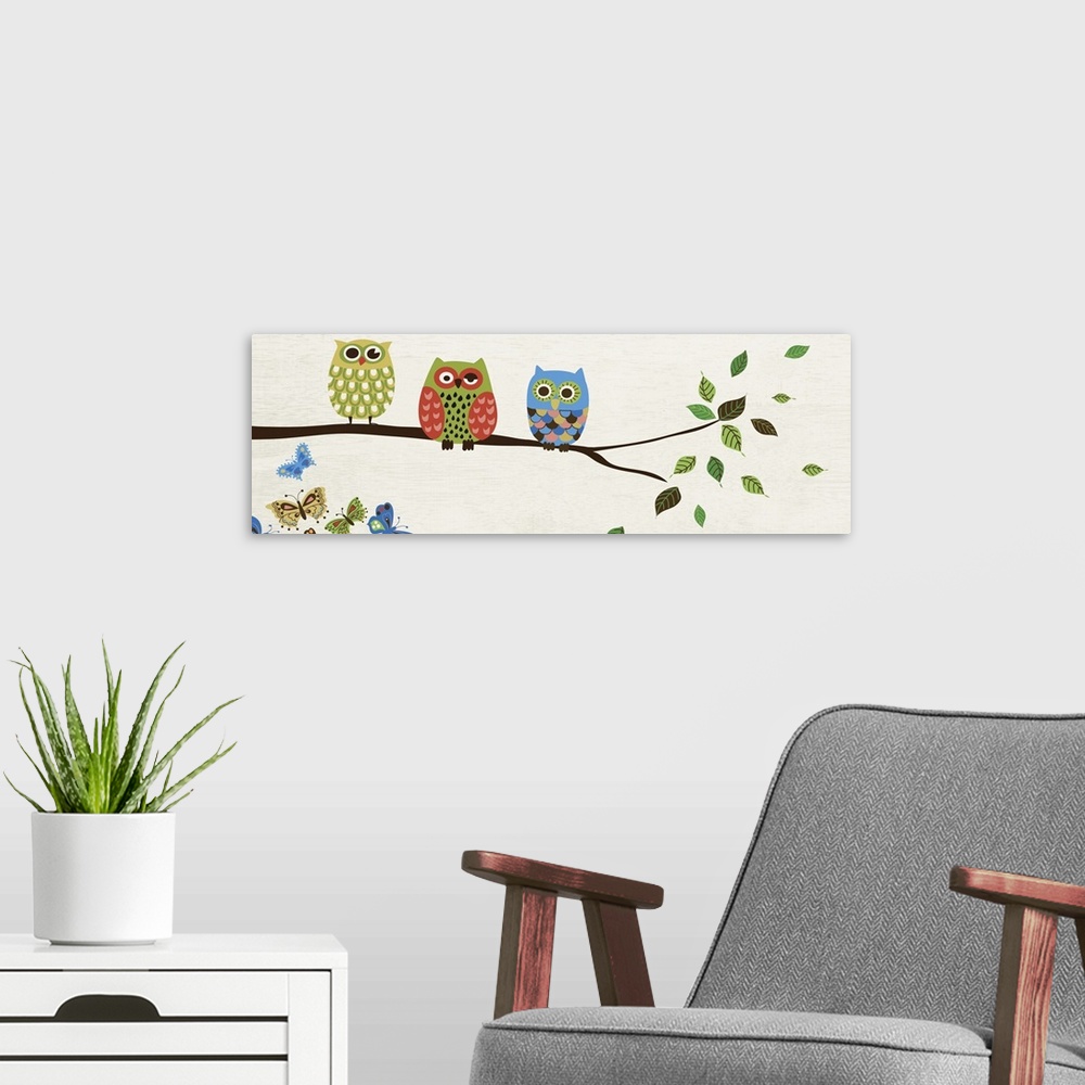 A modern room featuring Contemporary artwork of owls in multiple colors perched on a branch.