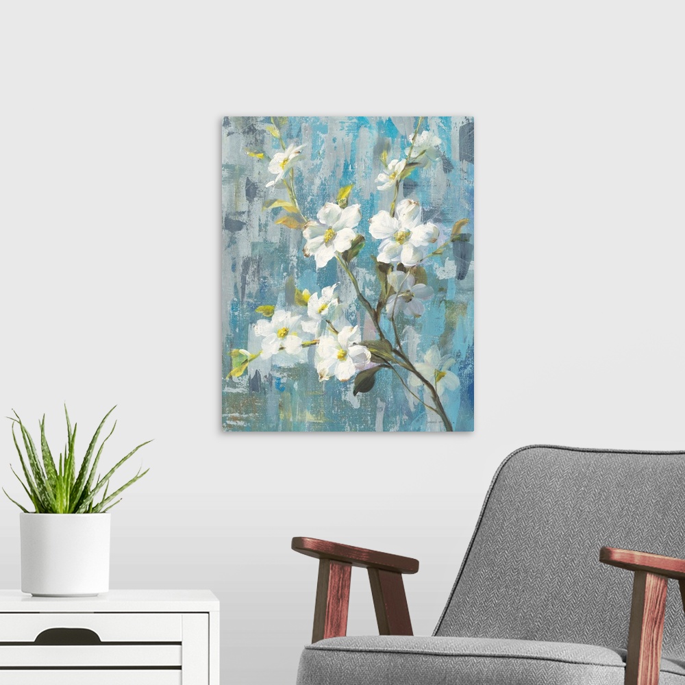 A modern room featuring Decorative artwork of white blooming flowers on a branch with a textured blue background.