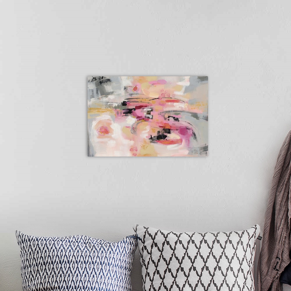 A bohemian room featuring A horizontal abstract image in shades of pink, yellow and gray.