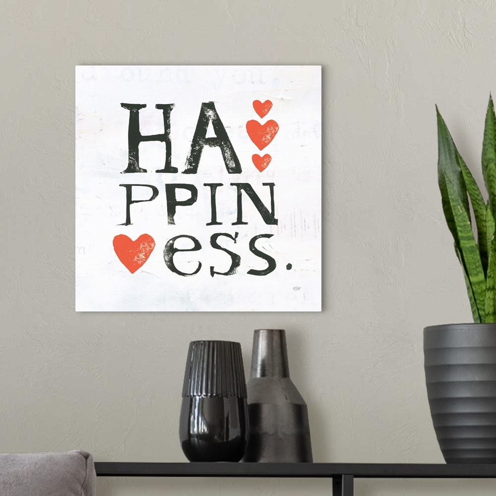 A modern room featuring Square painting with the word "happiness" written in three lines with red hearts on a white backg...