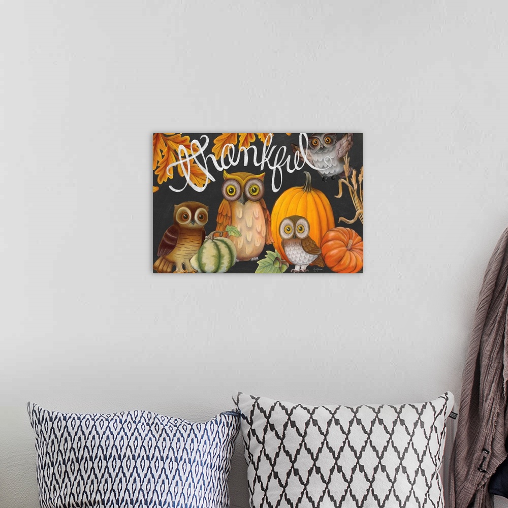 A bohemian room featuring Autumn chalkboard art of owls, pumpkins, and fall leaves with the phrase "Thankful" written in wh...
