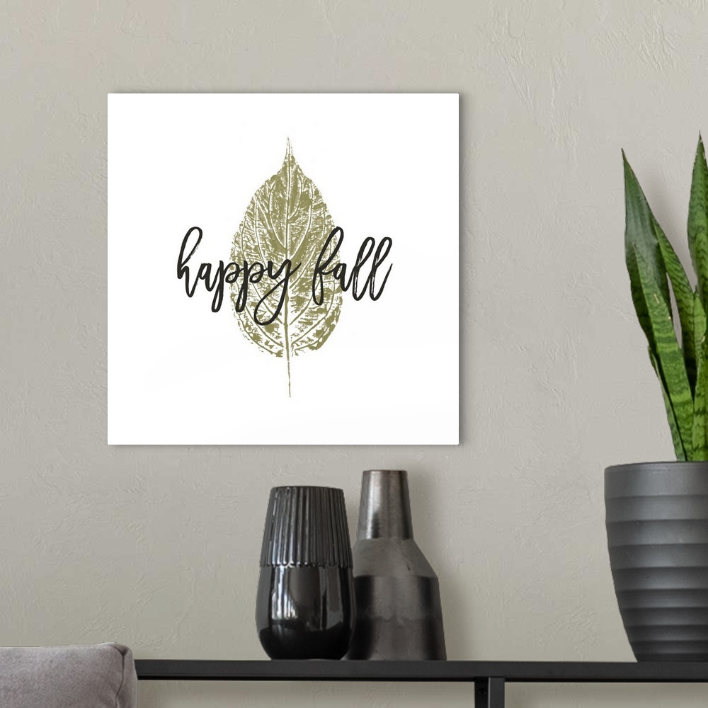 A modern room featuring "Happy Fall" over a metallic gold leaf on white.