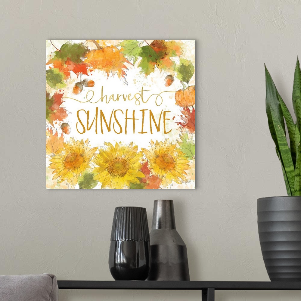 A modern room featuring "Harvest Sunshine" written inside a harvest wreath with Fall leaves, acorns, sunflowers, and pump...