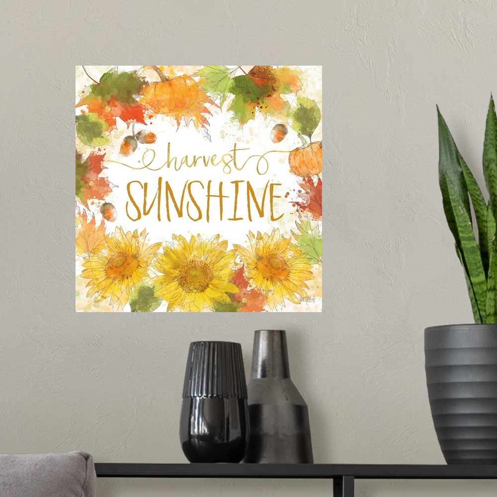 A modern room featuring "Harvest Sunshine" written inside a harvest wreath with Fall leaves, acorns, sunflowers, and pump...