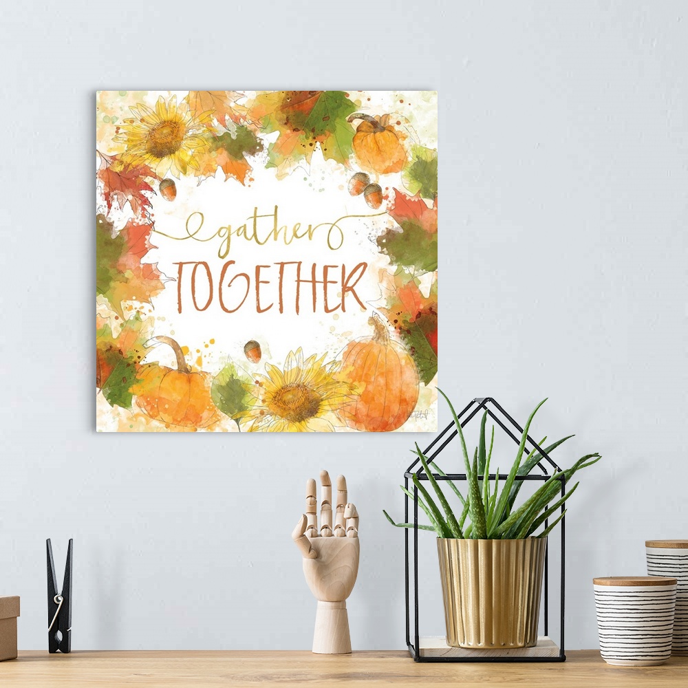 A bohemian room featuring "Gather Together" written inside a harvest wreath with Fall leaves, acorns, sunflowers, and pumpk...