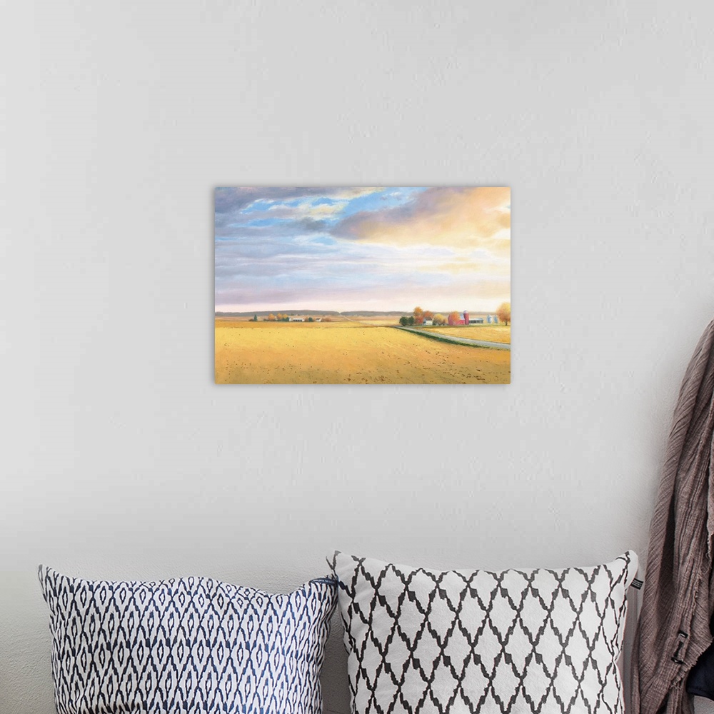 A bohemian room featuring Landscape painting of a rural area with golden fields and a road leading to the horizon.