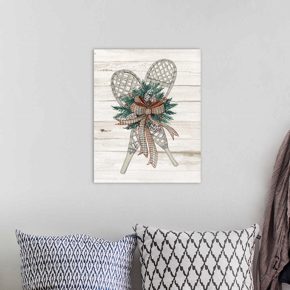 A bohemian room featuring Holiday wreath with snowshoes on a off white planked wall.