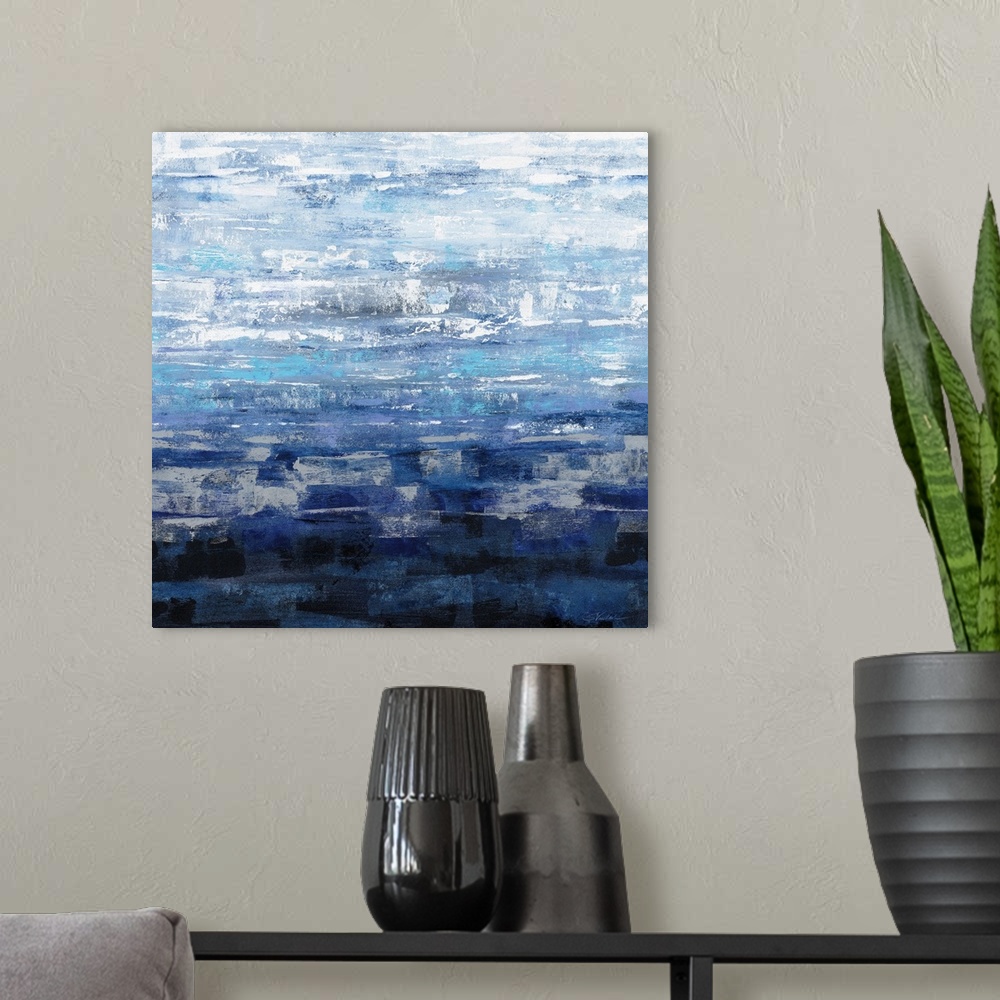 A modern room featuring Square abstract painting of textured brush strokes in a gradient of shades of blue.