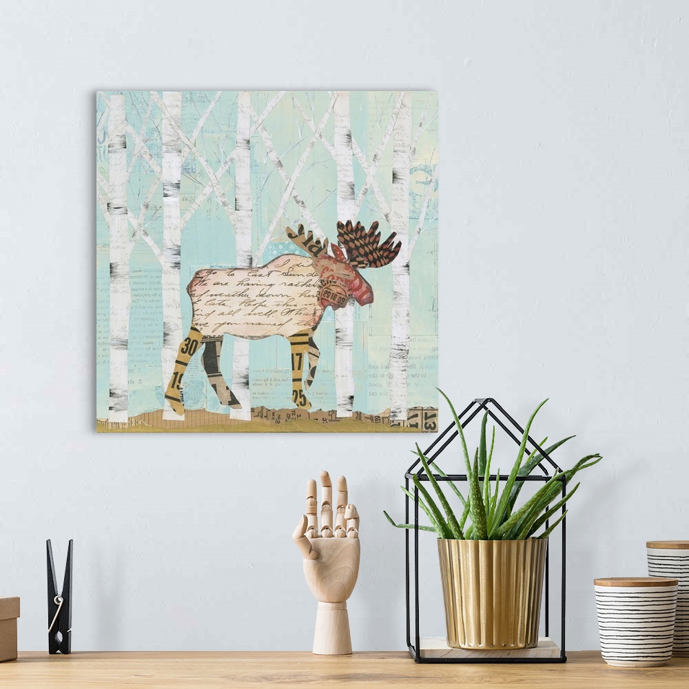 A bohemian room featuring Home decor artwork of a moose made from textiles and newsprint clippings against a pale blue fore...