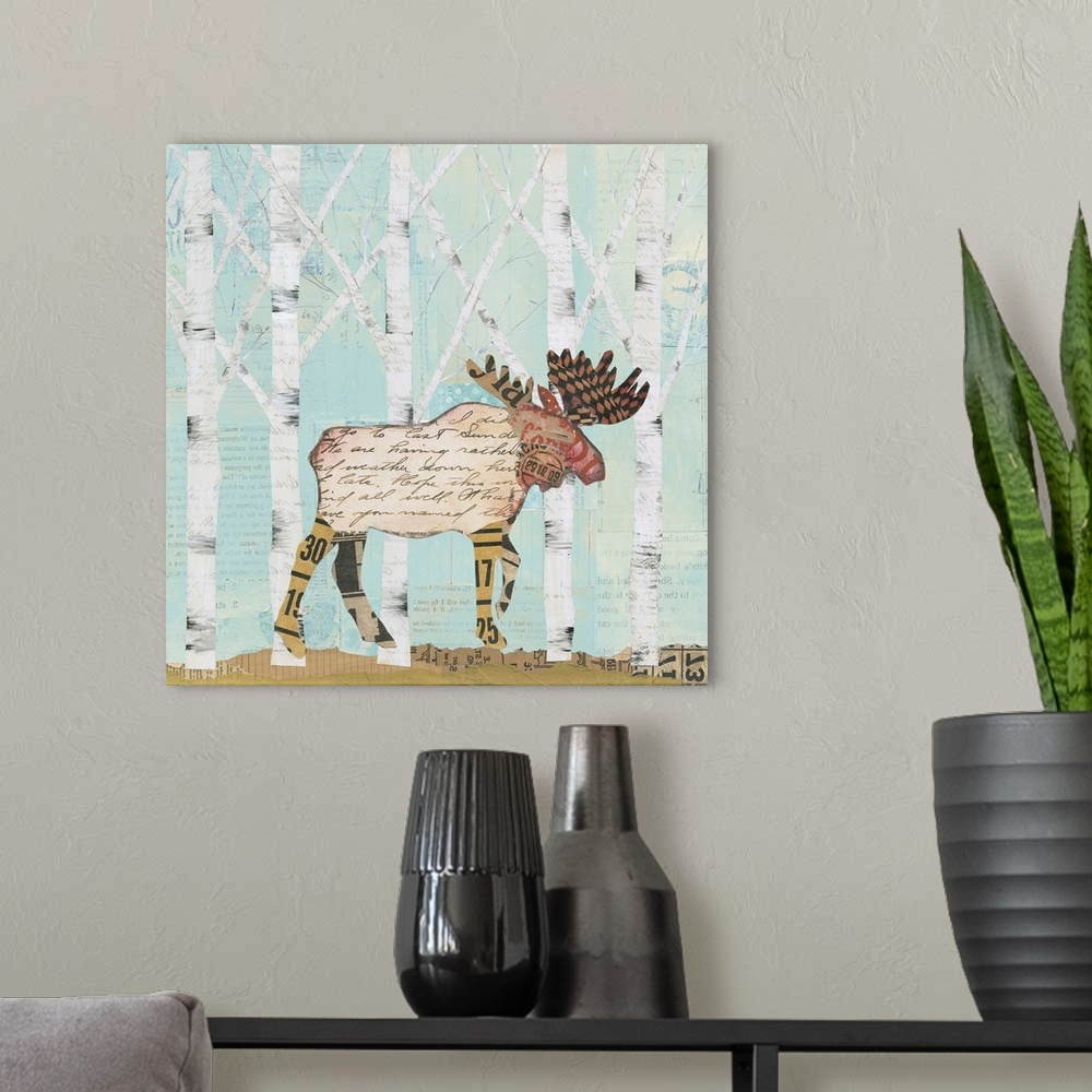 A modern room featuring Home decor artwork of a moose made from textiles and newsprint clippings against a pale blue fore...