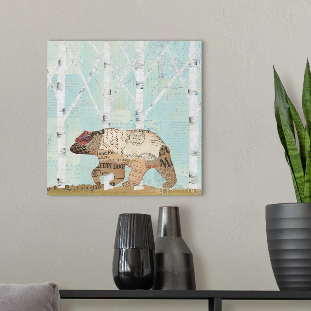 A modern room featuring Home decor artwork of a bear made from textiles and newsprint clippings against a pale blue fores...