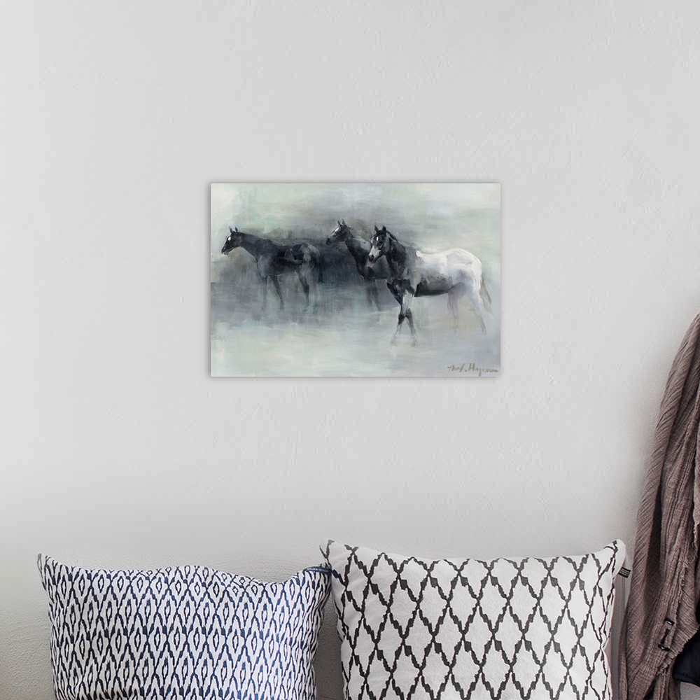 A bohemian room featuring Contemporary painting of three horses walking through the fog.