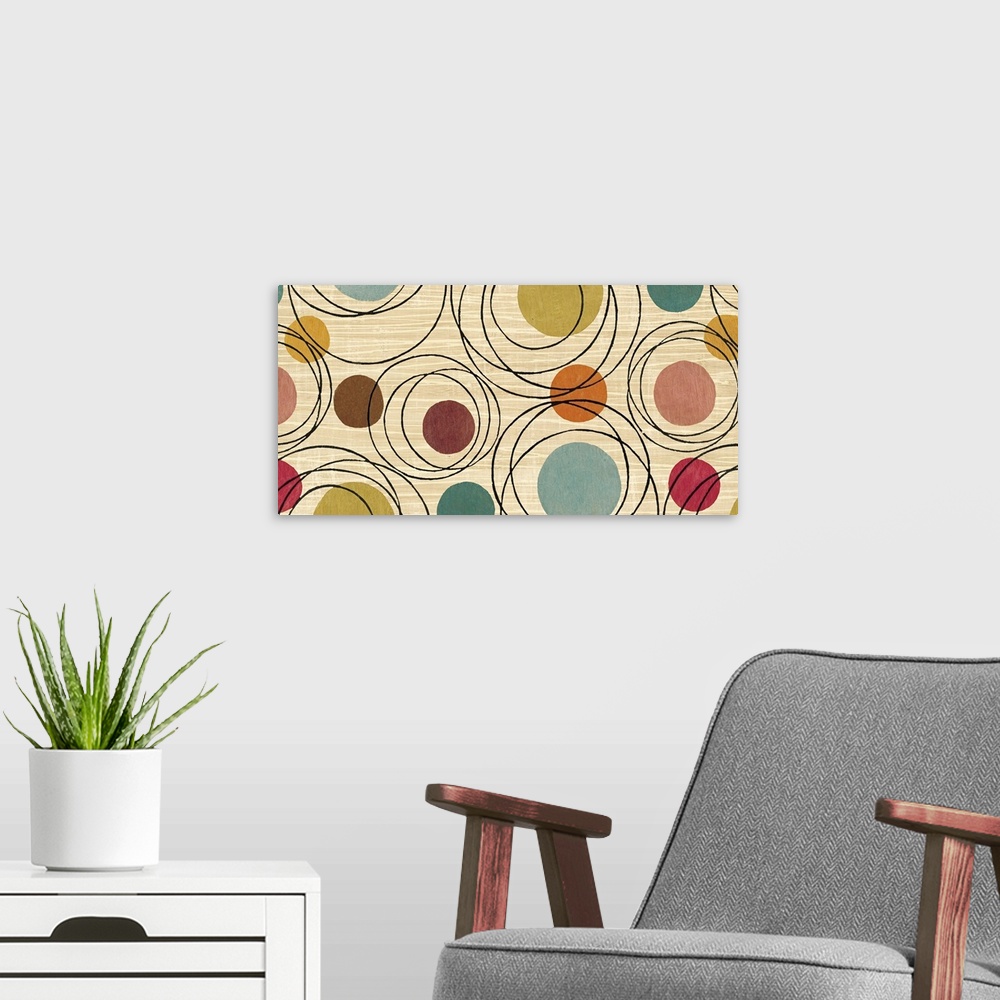 A modern room featuring Whimsical abstract painting of several different-colored circles and black rings on a neutral bac...