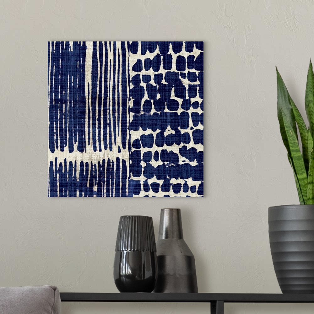 A modern room featuring Contemporary abstract artwork of different patterns in dark blue and cream.