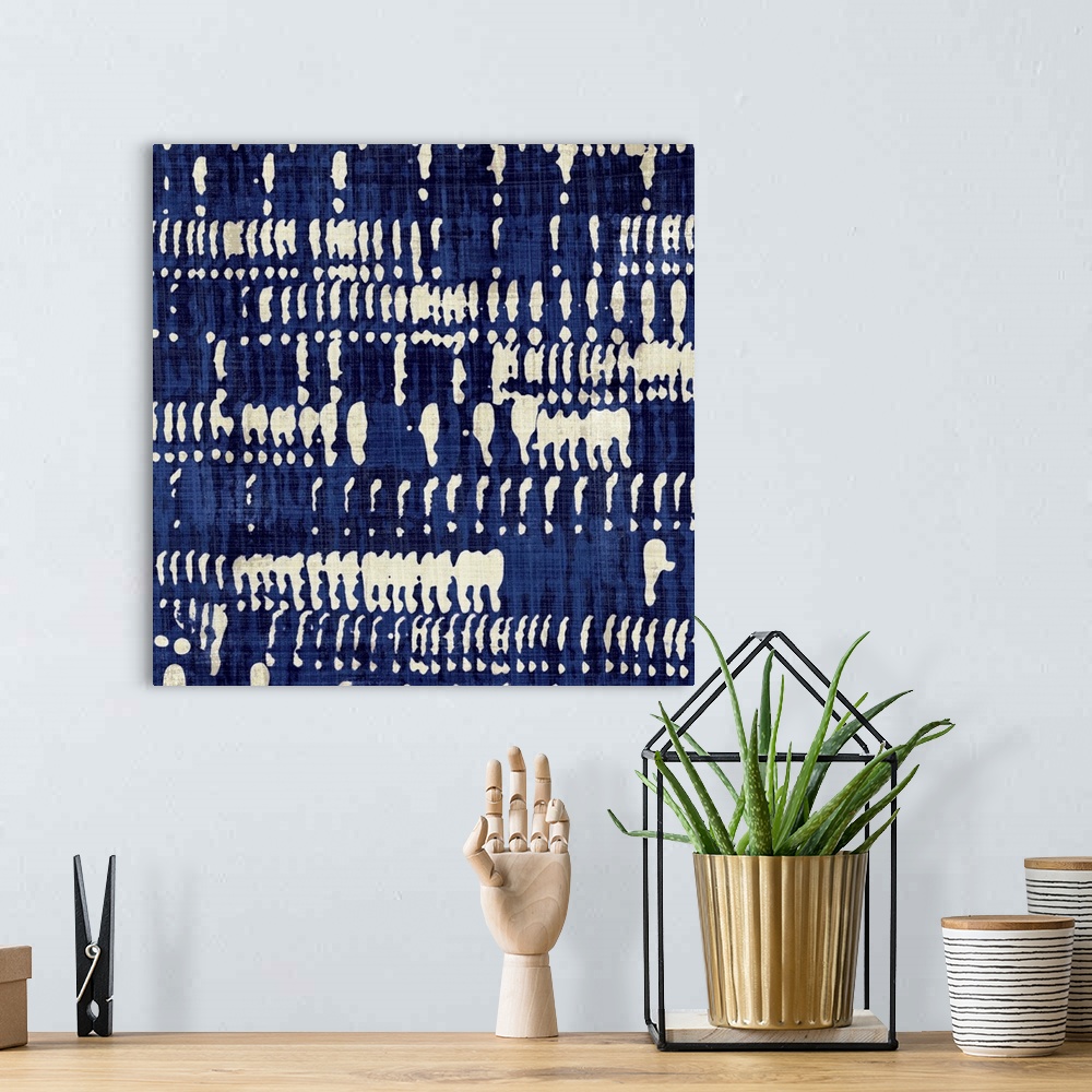 A bohemian room featuring Contemporary abstract artwork of different patterns in dark blue and cream.