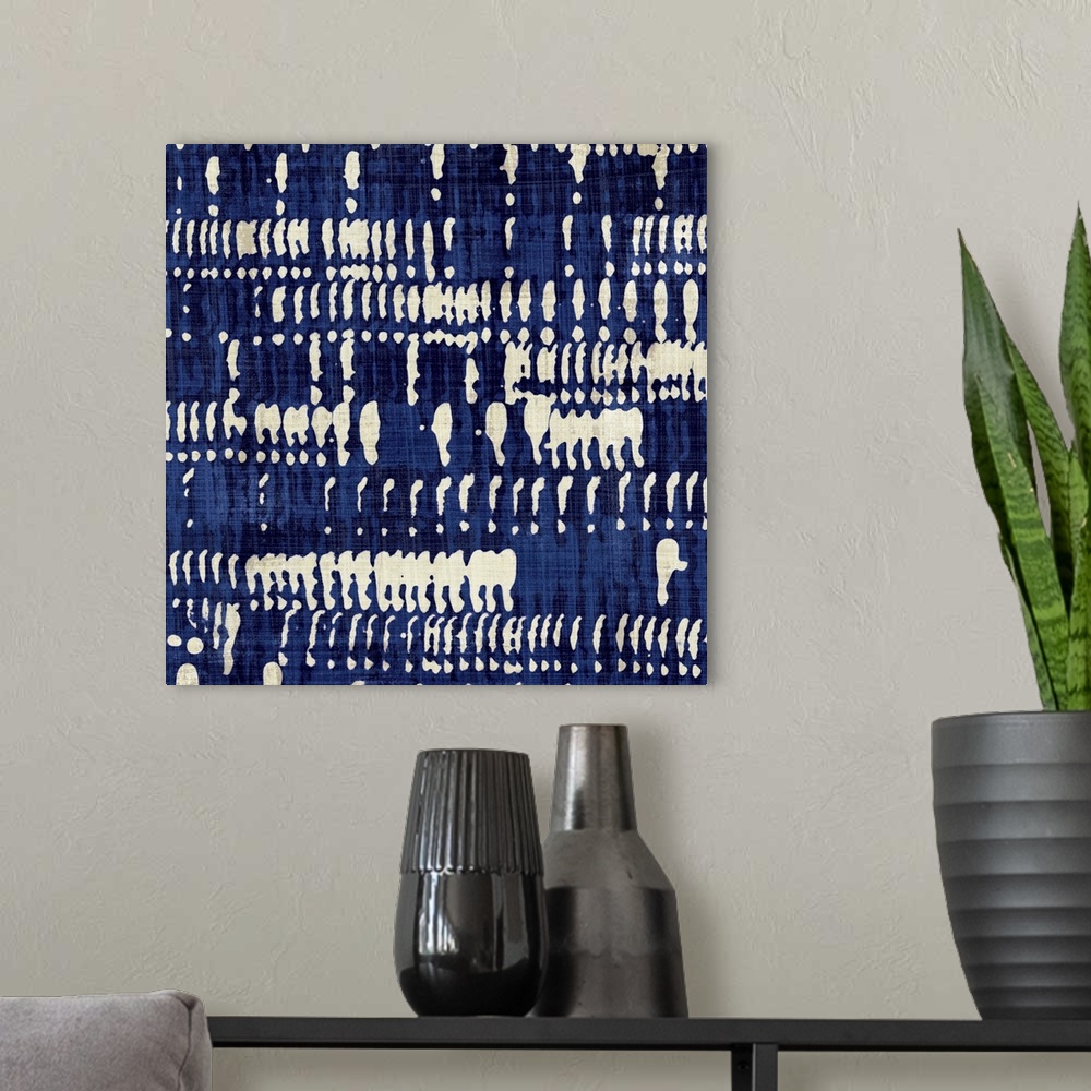 A modern room featuring Contemporary abstract artwork of different patterns in dark blue and cream.