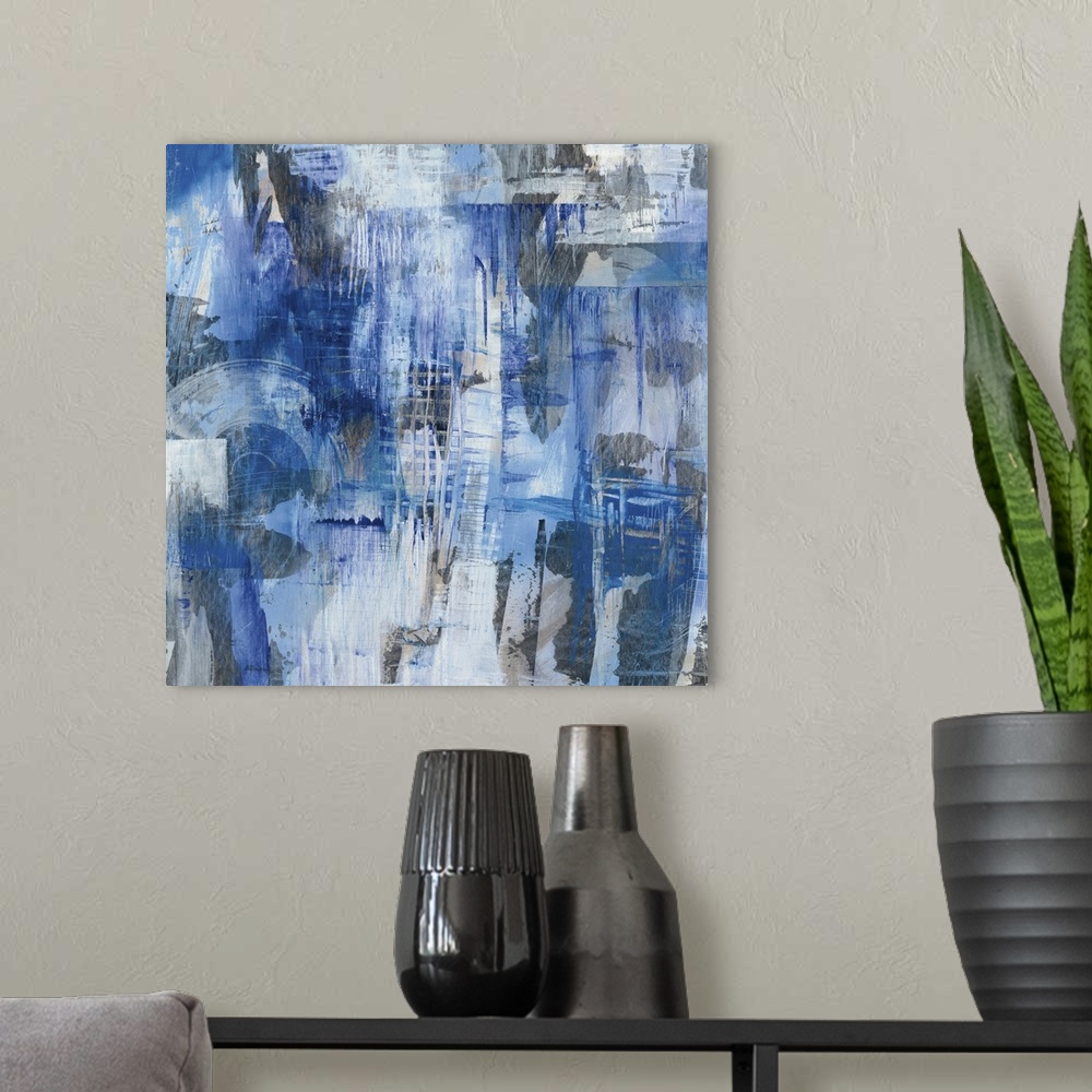 A modern room featuring Square abstract painting with blue, gray, and white hues creating different shapes and layers of ...