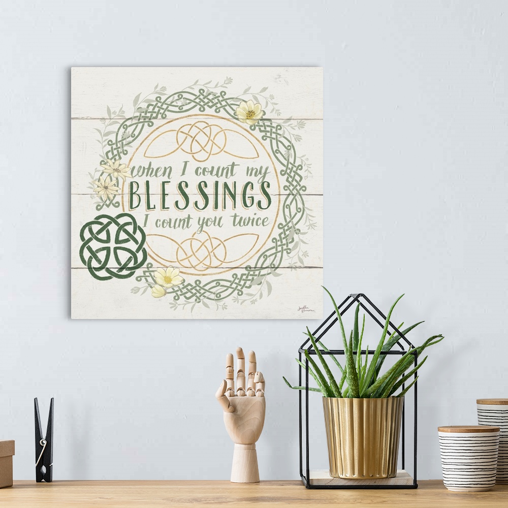 A bohemian room featuring "When I Count My Blessings I Count You Twice"  inside a Celtic knot wreath, on a wood paneled bac...