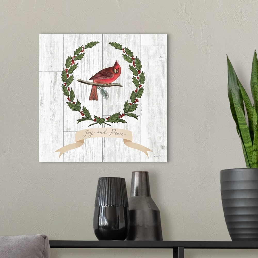A modern room featuring Decorative artwork of a cardinal surrounded by a wreath of holly with the words "Joy and Peace" b...