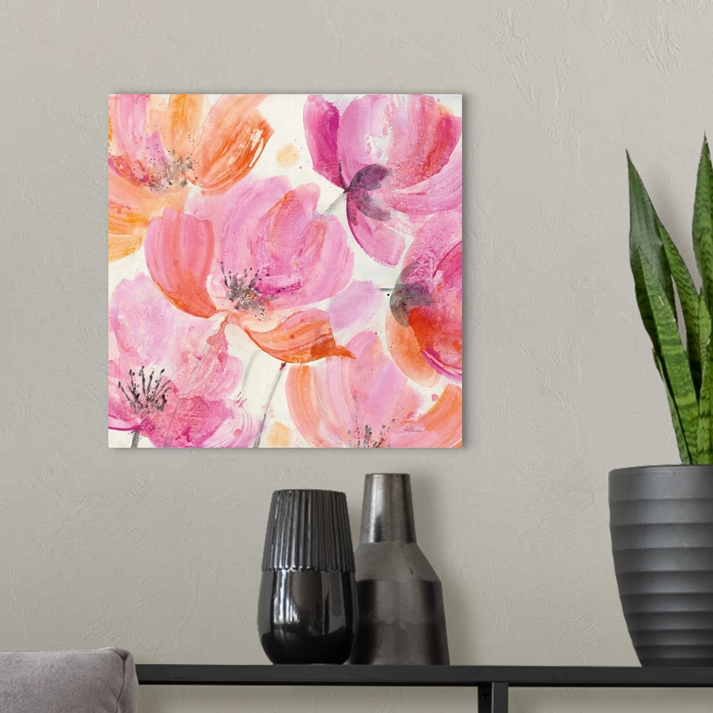A modern room featuring Square artwork of large, vibrant colored flowers in pink and orange.