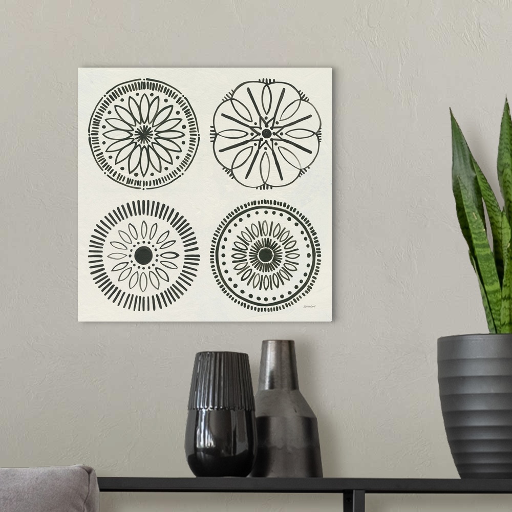 A modern room featuring Decorative artwork featuring four black medallion designs over a beige background.