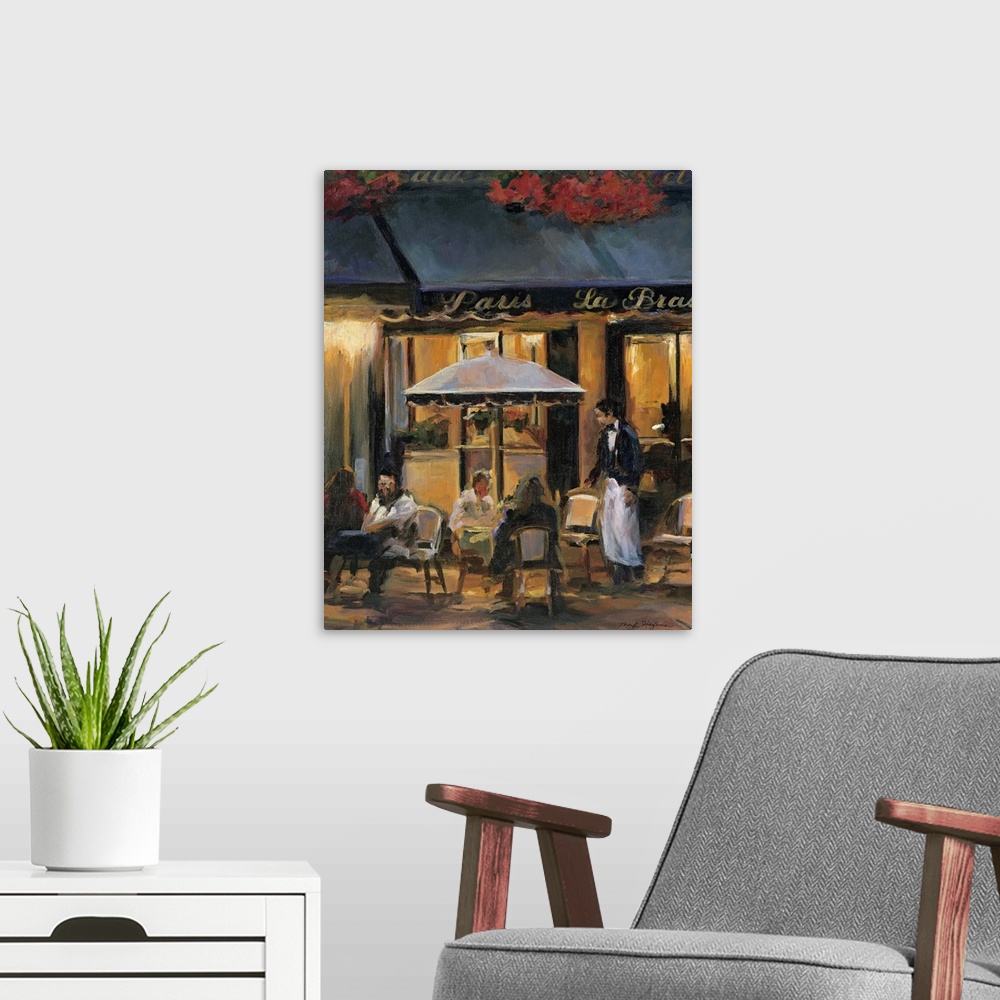 A modern room featuring Painting of street cafo with people sitting outside at tables at night with waiter attending to t...