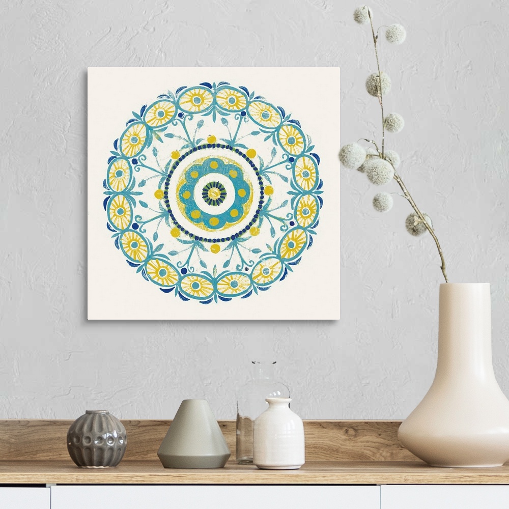A farmhouse room featuring Square decor with a mandala design in the center made in shades of blue, green, and yellow on a w...