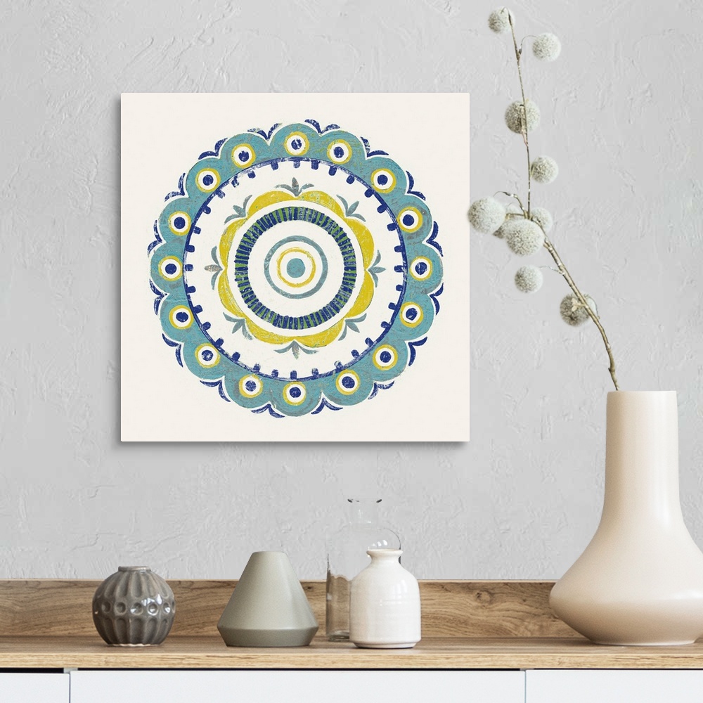 A farmhouse room featuring Square decor with a mandala design in the center made in shades of blue, green, and yellow on a w...