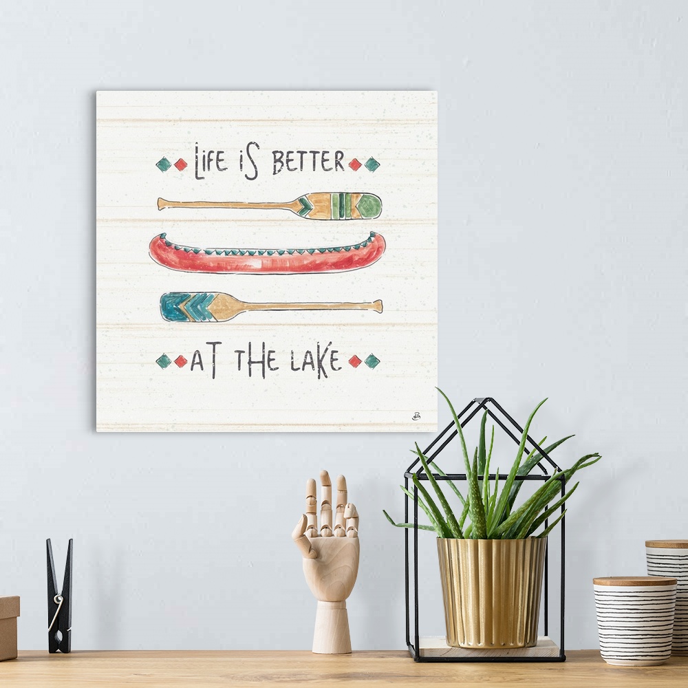 A bohemian room featuring A decorative design of a canoe and oars with the text "Life Is Better At The Lake".  There are fa...