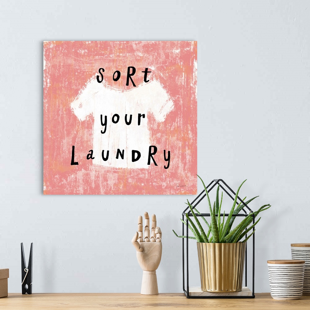 A bohemian room featuring "Sort your Laundry" square laundry room decor.