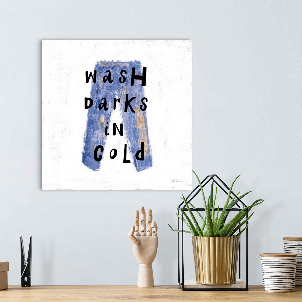 A bohemian room featuring "Wash Darks in Cold" square laundry room decor.