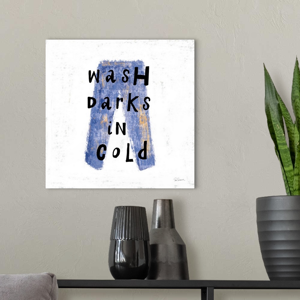 A modern room featuring "Wash Darks in Cold" square laundry room decor.