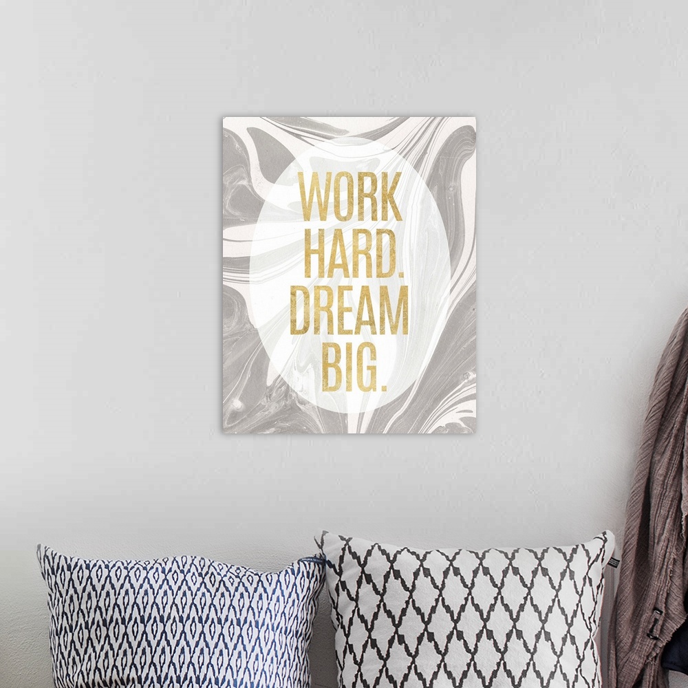 A bohemian room featuring "Work Hard. Dream Big." written in gold inside a white translucent oval on a gray and white marbl...