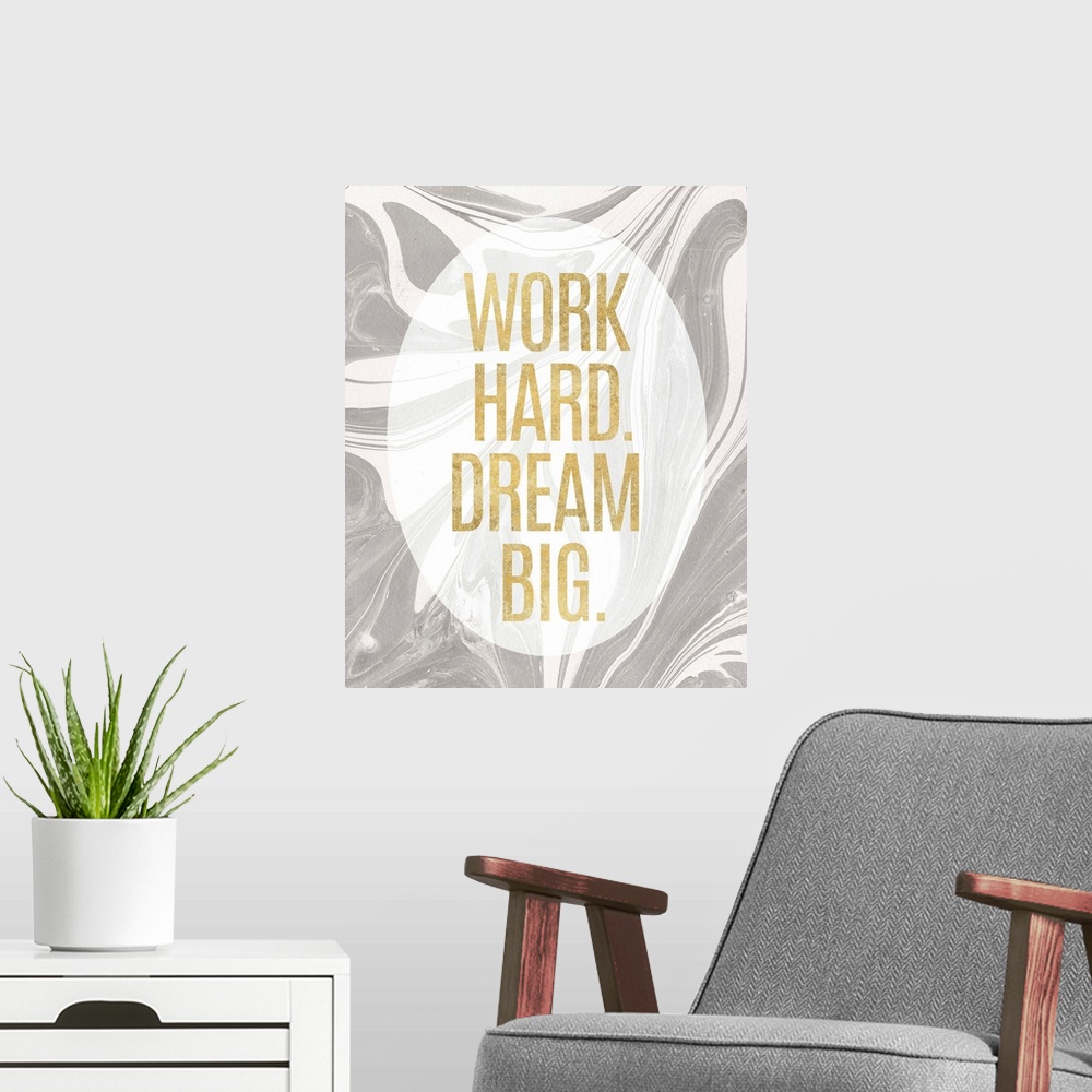 A modern room featuring "Work Hard. Dream Big." written in gold inside a white translucent oval on a gray and white marbl...