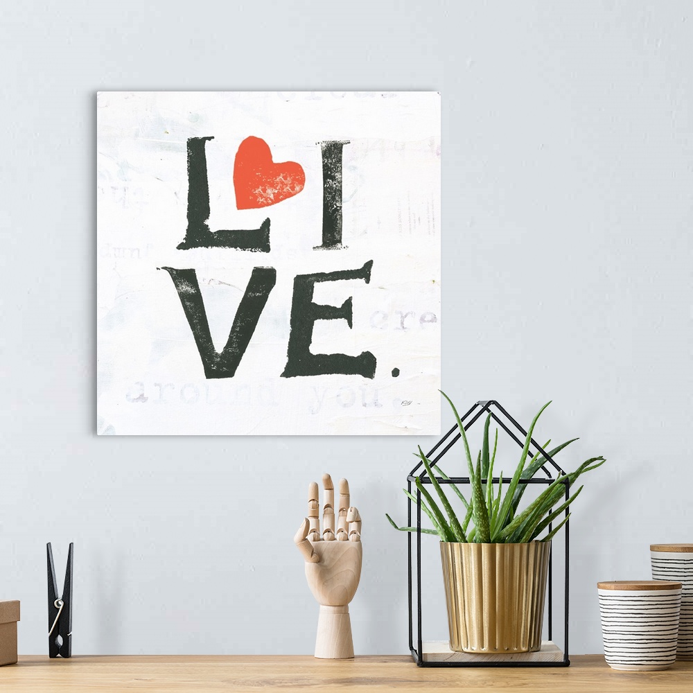 A bohemian room featuring Square painting with the word "live" written in two lines with red hearts on a white background w...