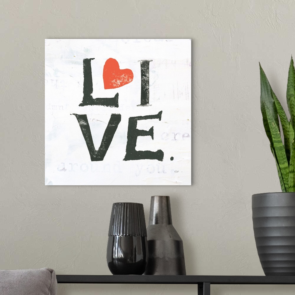 A modern room featuring Square painting with the word "live" written in two lines with red hearts on a white background w...