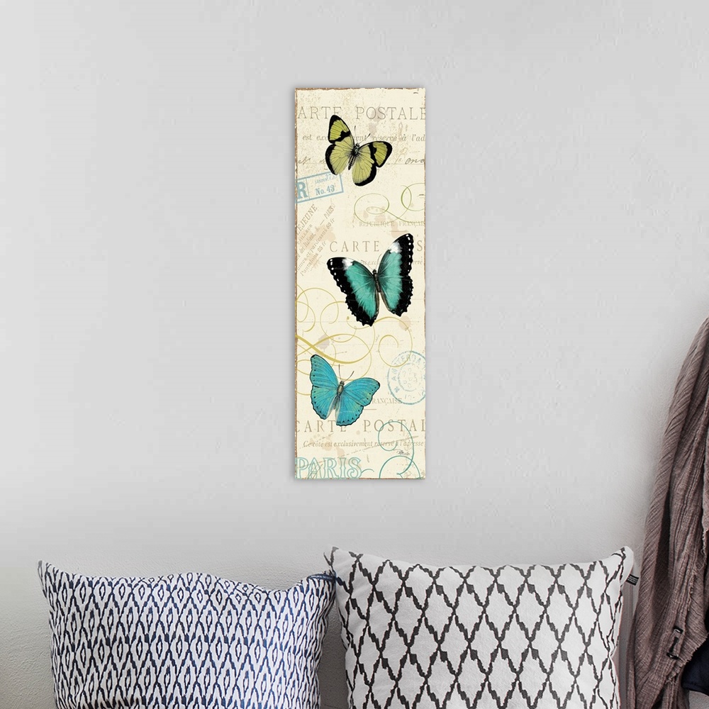 A bohemian room featuring Contemporary artwork of three butterflies running vertically in the frame. Against a beige backgr...