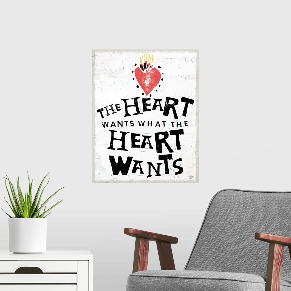 A modern room featuring Decorative art with the phrase "The Heart Wants What The Heart Wants" written in black with an il...