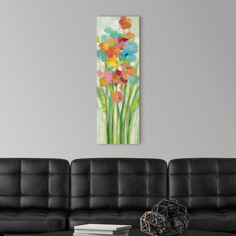 A modern room featuring A long vertical painting of a group of stemmed flowers and leaves in cheerful colors.