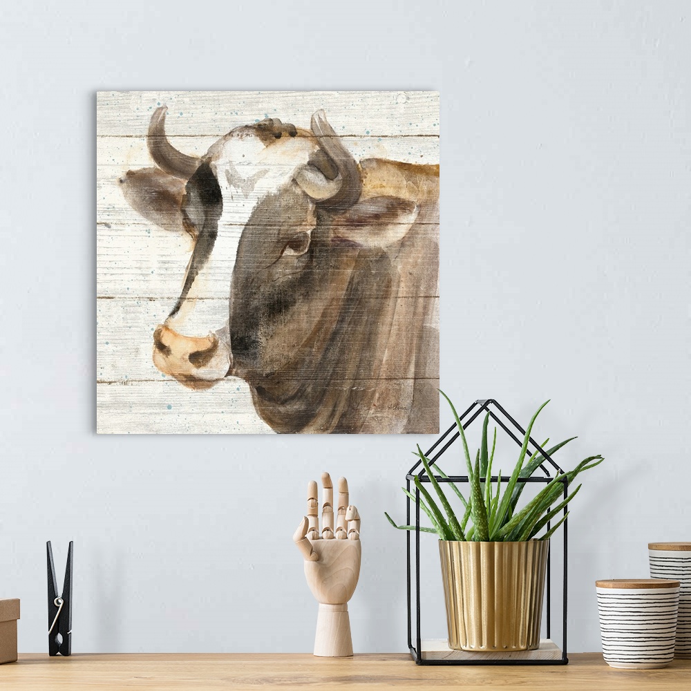 A bohemian room featuring Decorative rustic artwork of a cow portrait over a wood panel background.